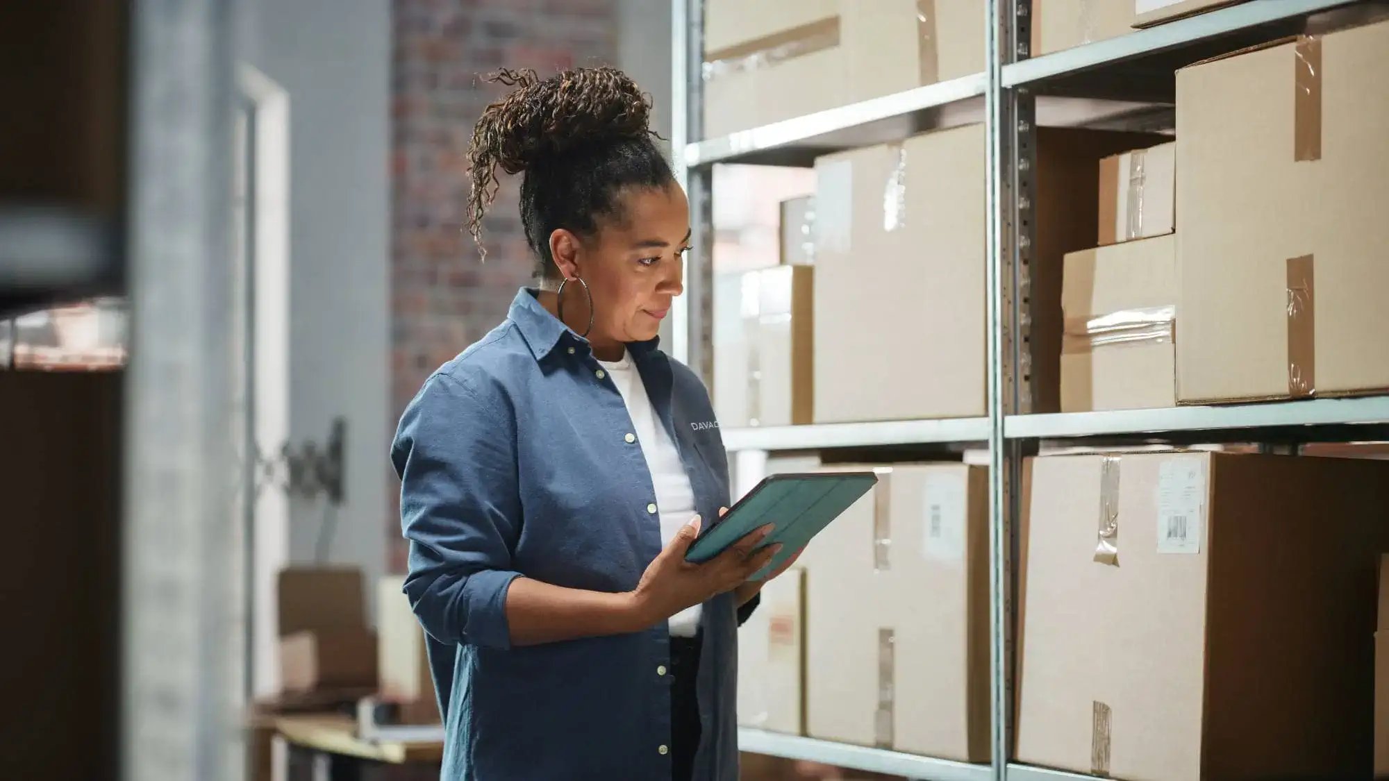 Woman with ipad near boxes image