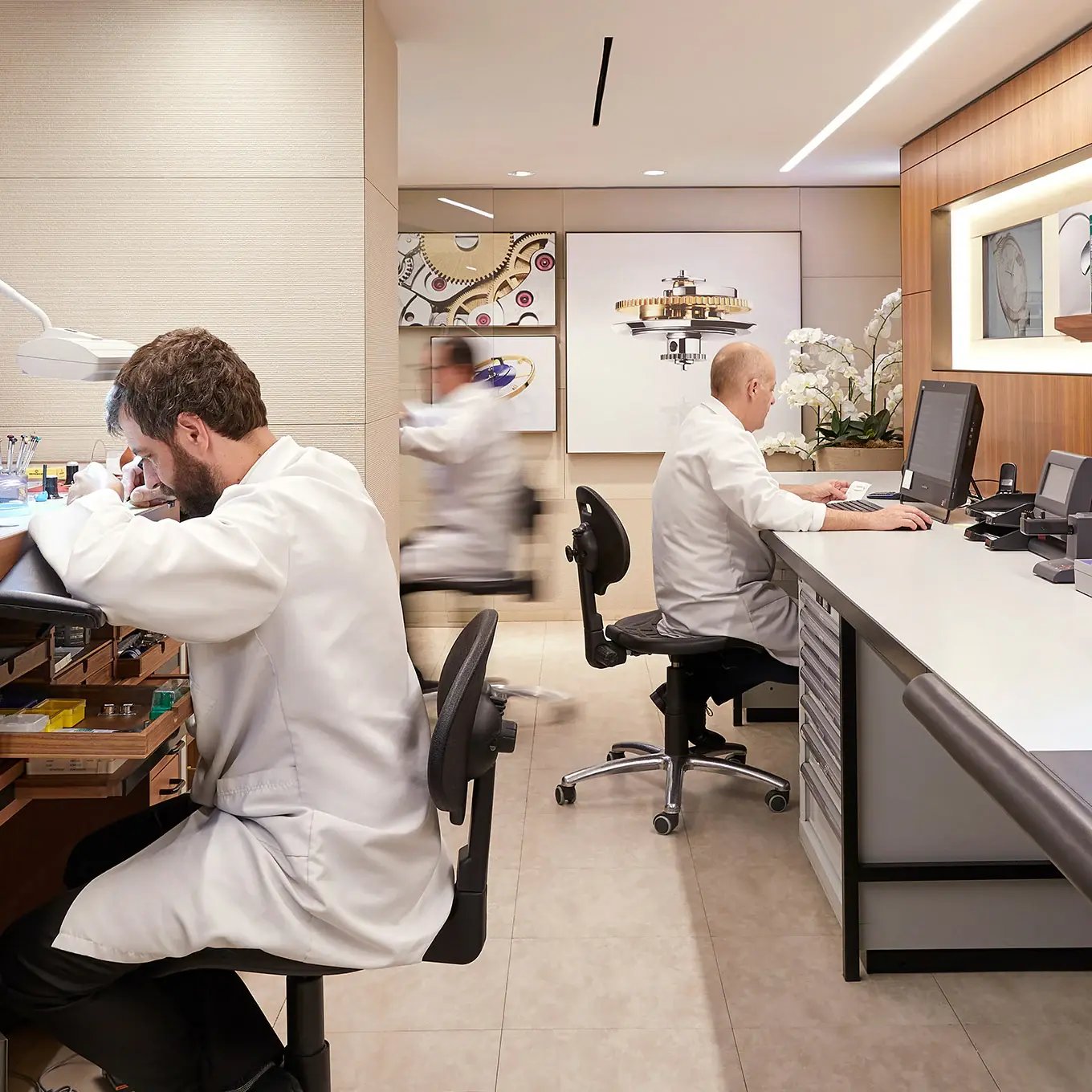 Workers fixing watches with HVAC service on roof, exemplifying Watches of Switzerland's comprehensive facilities maintenance.