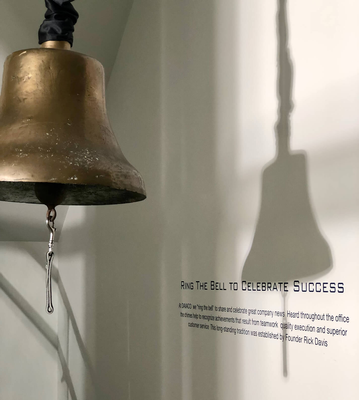 Gold bell hanging in the DAVACO office