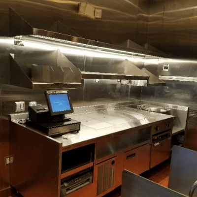 Stainless kitchen prep station with an employee touch screen at a newly remodeled Chipotle restaurant.