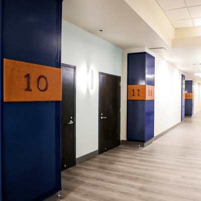 Bank of America Suite entrance with blue and orange numbered doors at the Houston Astros Stadium