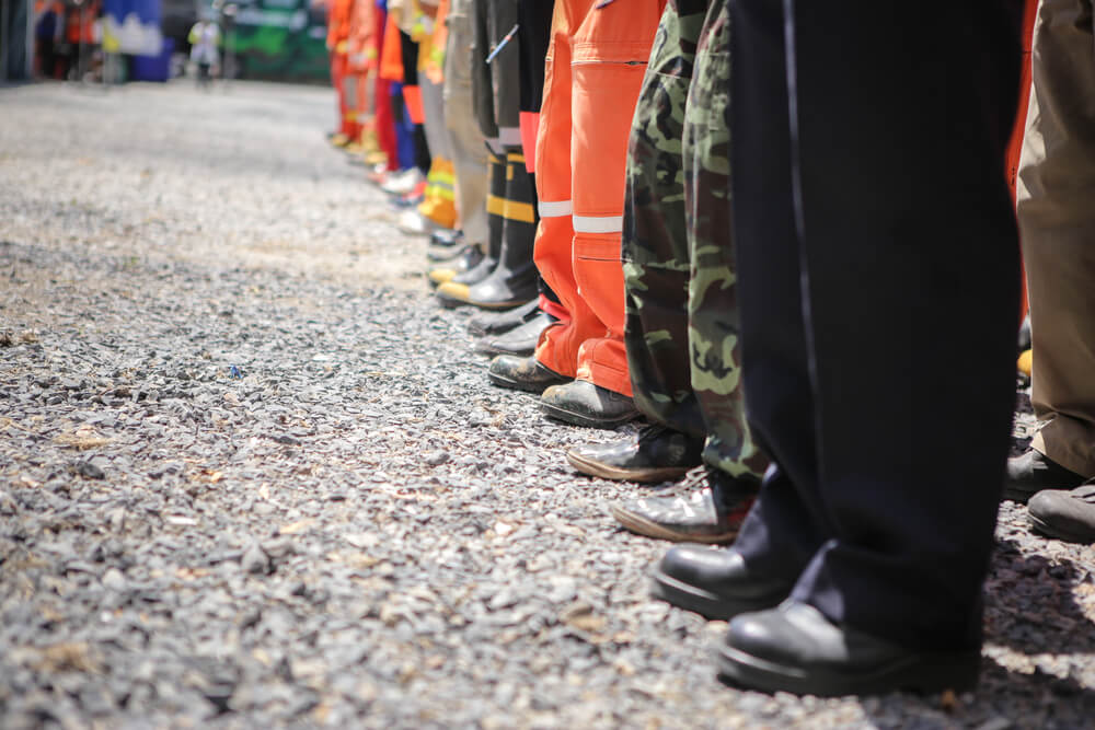 Line of boots and protective shoes of emergency response personnel.