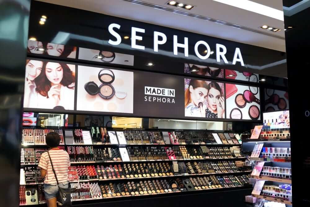 Interior of Sephora store, showing colorful new cosmetics and models highlighted on wall displays.
