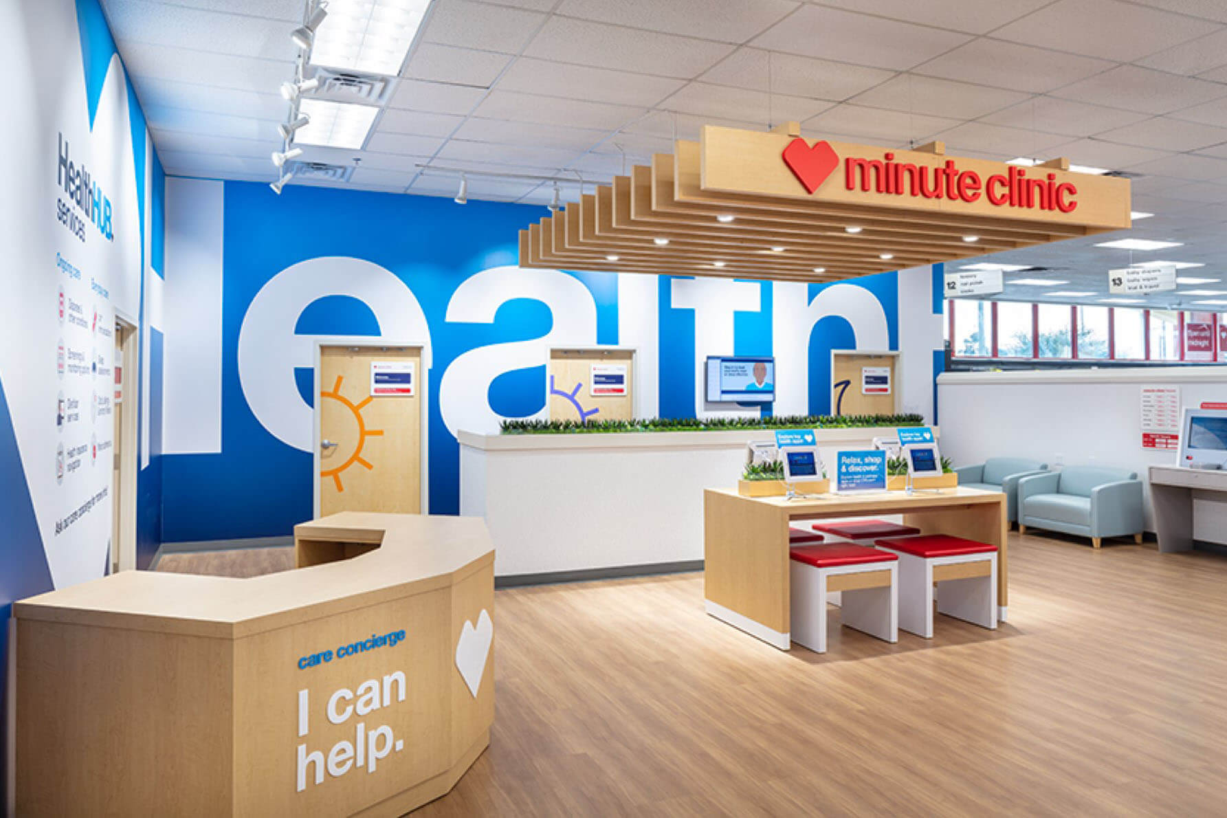 Interior of newly renovated CVS Health store, showing oak floors, patient stations and blue CVS Health banners.