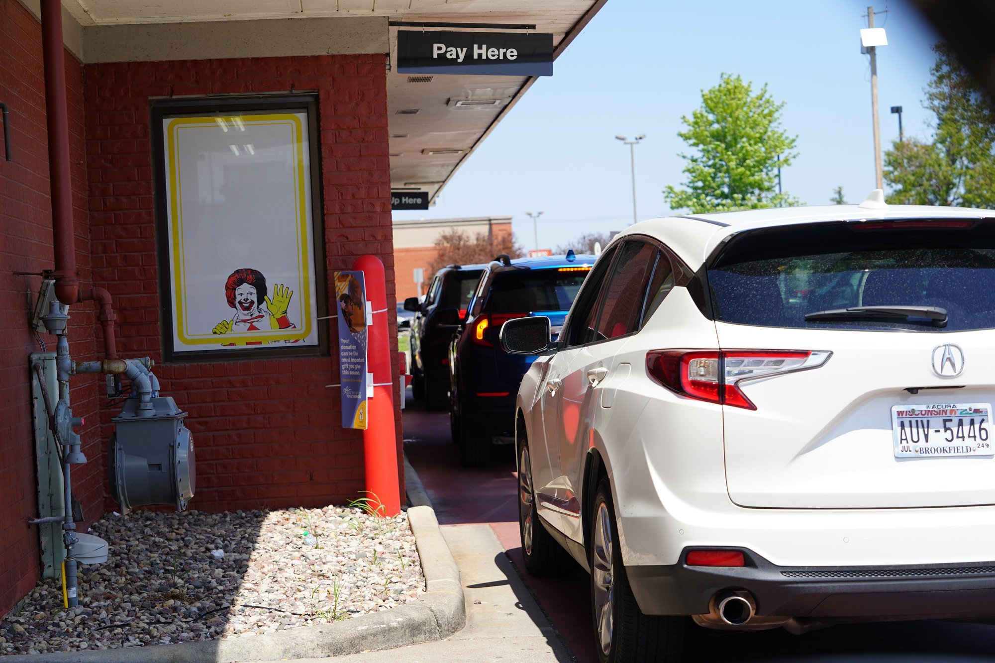McDonalds Drive thru showing Ronald McDonald waving