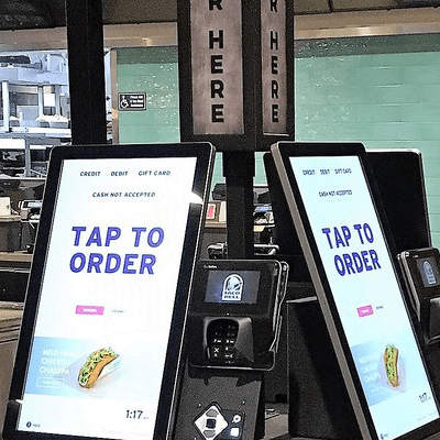 New LCD touch screens inside a Taco Bell restaurant, allowing customers to self-order and pay on-site for faster pick-up service.