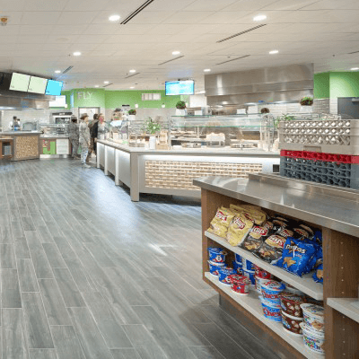 Steel and wood grain food counter at a newly remodeled US Air Force dining facility, stocked with ready-to-go meal items.