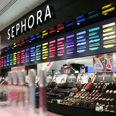 Rainbow of bright colors on a black wall with a Sephora logo